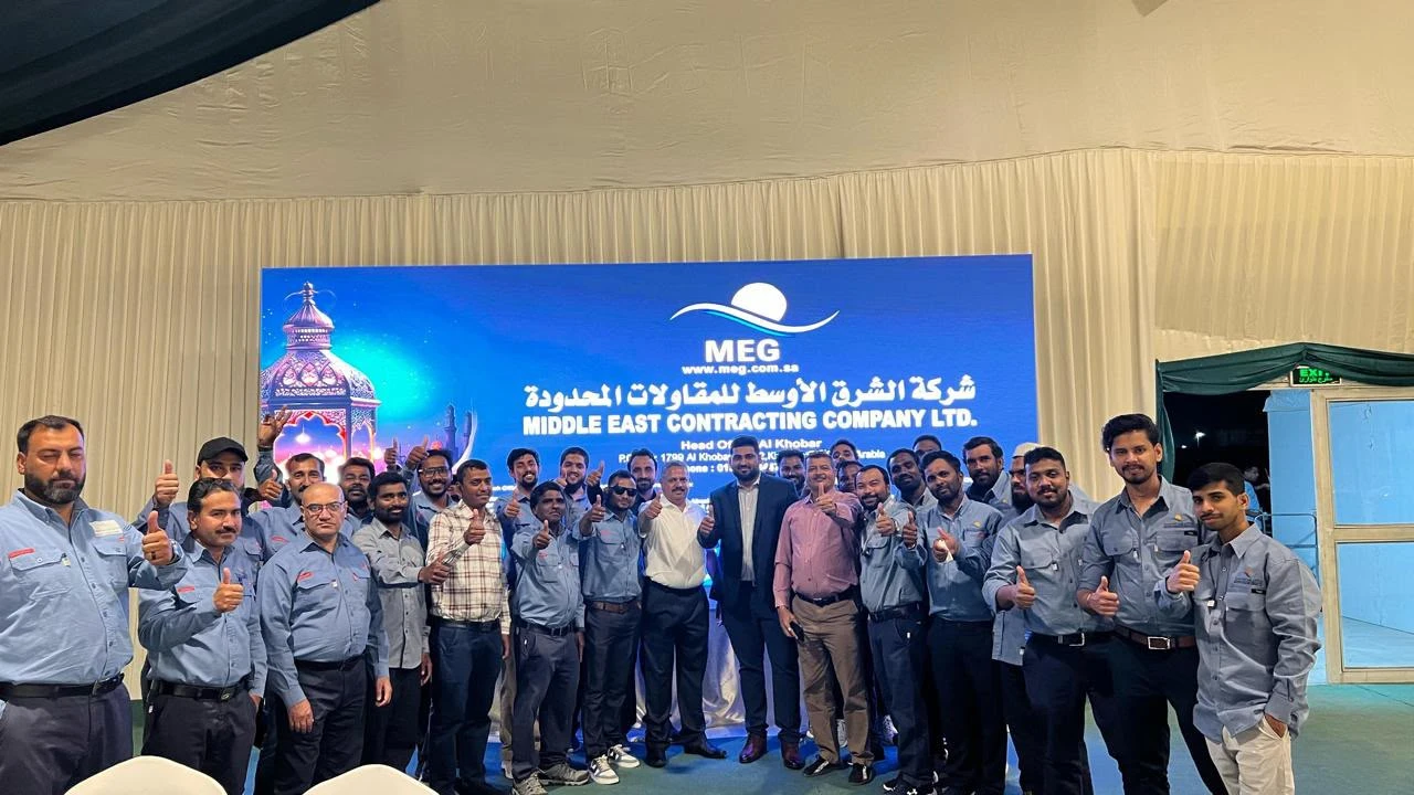 MEG full team at Iftar gathering with company banner